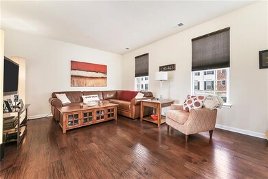 Family room with hardwood floors, high ceiling and