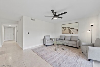 Tiled living room featuring ceiling fan