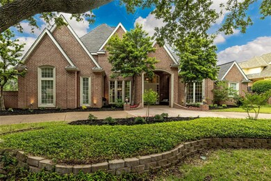 Mature trees and lush landscaping grace the elegant entry.
