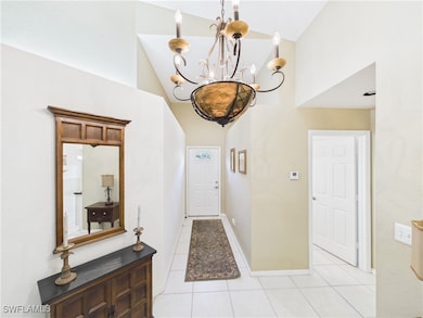 Entrance foyer featuring baseboards, a chandelier,