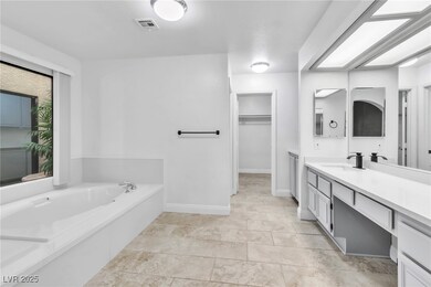 Bathroom with a spacious closet, visible vents, ba