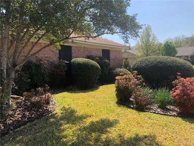 Beautiful landscaping adds charm to this pretty 3/
