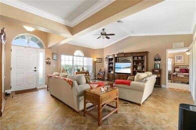 Tiled living room with vaulted ceiling, ceiling fa