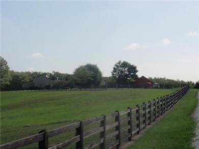 View Entering the Farm from long, level Gravel Driveway.  Plush Pastures....Room for Several Horses!