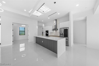 Kitchen featuring modern cabinets, wall chimney ra