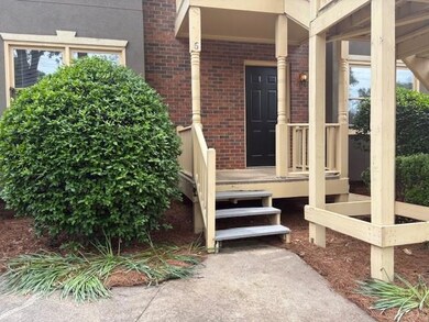 Property entrance with brick siding, stucco siding