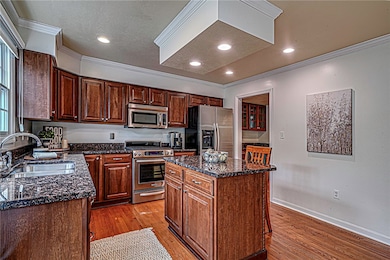 The kitchen is a chef's dream featuring sleek stai