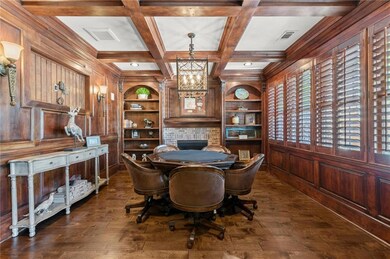 Rich cherry wood paneling sets the tone in the custom poker room, complete with a dedicated ventilation system, gas fireplace, and built-in bookshelves—offering the ultimate space for intimate gatherings and game nights in refined style