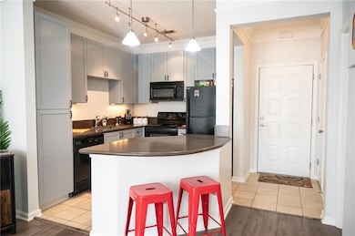 Kitchen with light tile flooring, gray cabinetry, 