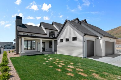 Modern farmhouse featuring a garage, roof with shingles, a front yard, and a chimney
