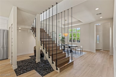 Staircase with wood finished floors, baseboards, r
