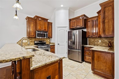 Kitchen featuring stainless steel appliances, a si