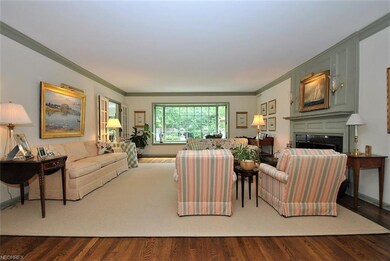 Spacious formal living room with wood flooring, fi