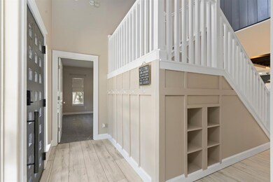 Corridor featuring light wood-style floors and st