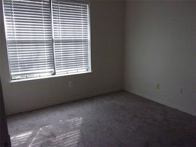 Carpeted empty room with baseboards