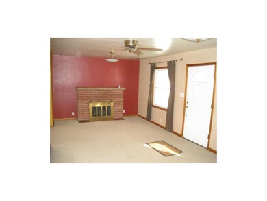 Woodburning fireplace with gas logs in living room