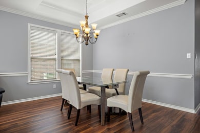 Dining area featuring a chandelier, dark wood-sty