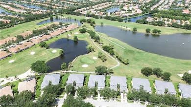 Aerial overview of property's location with nearby suburban area, a golf course, and a large body of water