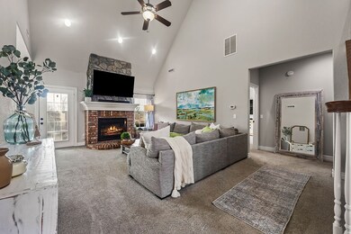 View of the living room and entrance to primary bedroom.