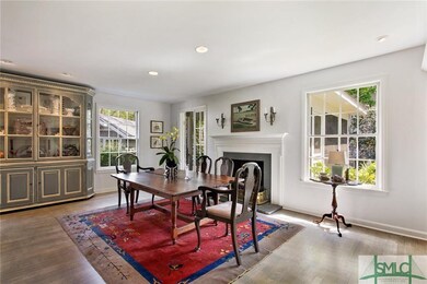 LIVING/DINING AREA WITH HARDWOOD FLOORS AND A FIRE