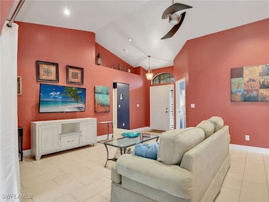 Living room with baseboards, high vaulted ceiling,