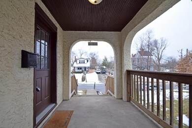 The charming covered porch is a great place to enj