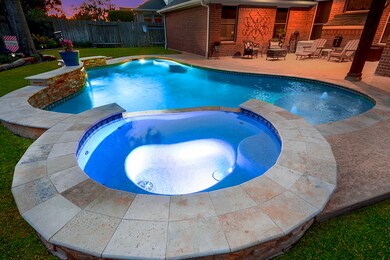 Pool features a custom waterfall. This is an AMAZING backyard. This pool offers high-tech features, and you can fill it using your app or smart device.