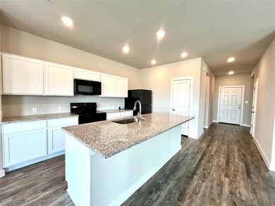 Kitchen with black appliances, a sink, a kitchen 