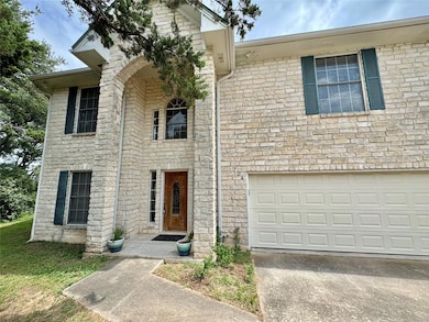 View of front of house with driveway, stone sidin