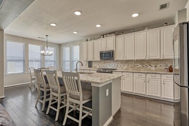 The spacious island kitchen includes fresh paint and recent appliances.
