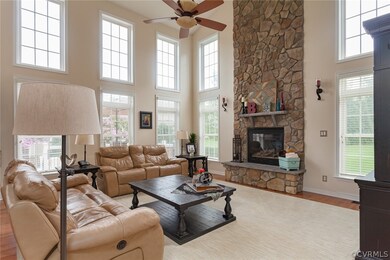 Grand 2-story family/living room with stone has fi