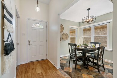 Bright breakfast room just off the front entry with a lovely corner window and updated light fixture.