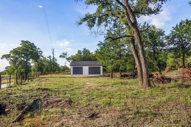 View of yard with a garage and an outdoor structu