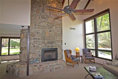 Dramatic stone gas log fireplace in LR and woodsto