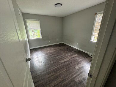 Spare room with dark hardwood / wood-style floorin