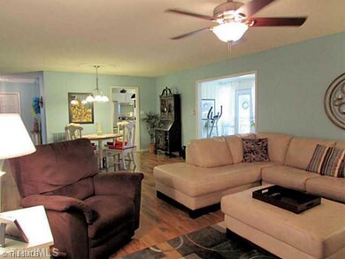 Living Room. Living room opens to the bright sunroom and dining area.