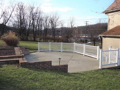Concrete and brick 2 tiered patio and easy to main