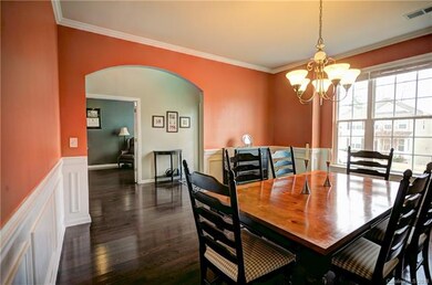 Dining Room with elegant arched entry, wainscoting
