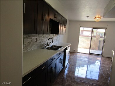 Kitchen featuring a sink, tasteful backsplash, lig