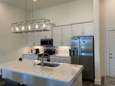 Kitchen with a center island with sink, stainless 