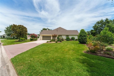 View of right side of home and brick patterned driveway and side garages