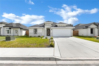 View of front of property with a front lawn and a garage