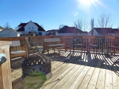 The large deck overlooks the fenced backyard. It is a great place to relax or entertain! 