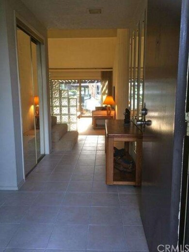 entry way leading to large living room. closet wit
