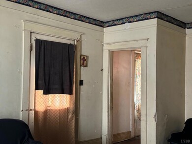 Both doors open off the front porch. The door on the right enters into the stairwell to go upstairs