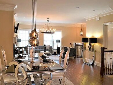 Dining space featuring baseboards, wood finished floors, a notable chandelier, and crown molding