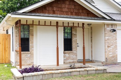 View of front of home with covered porch and bric