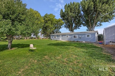 Rear view of property featuring a lawn