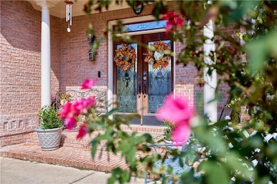 Doorway to property featuring brick siding