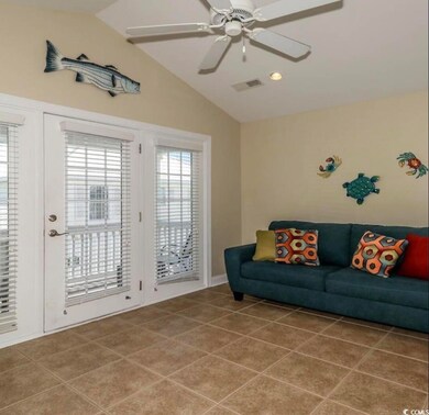 Tiled living room featuring ceiling fan, lofted ce